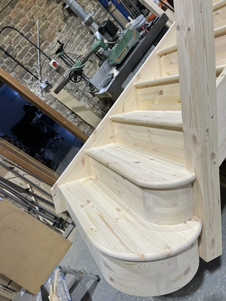 Handcrafted wooden staircase in workshop setting