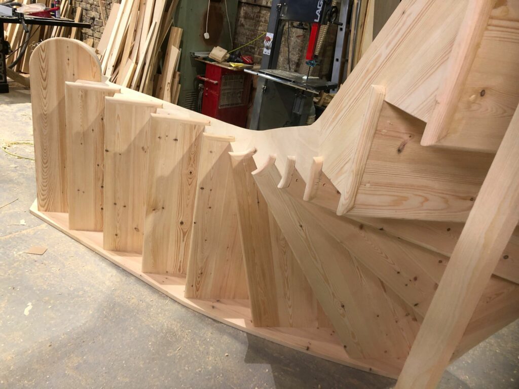Softwood cut curved string staircase