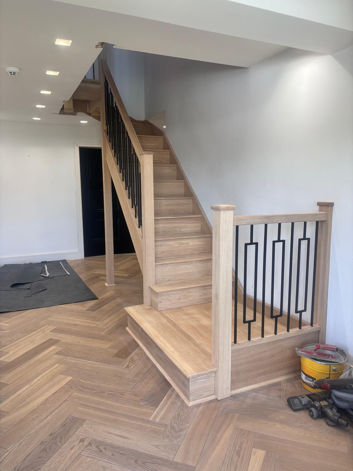 Oak staircase with black metal spindles