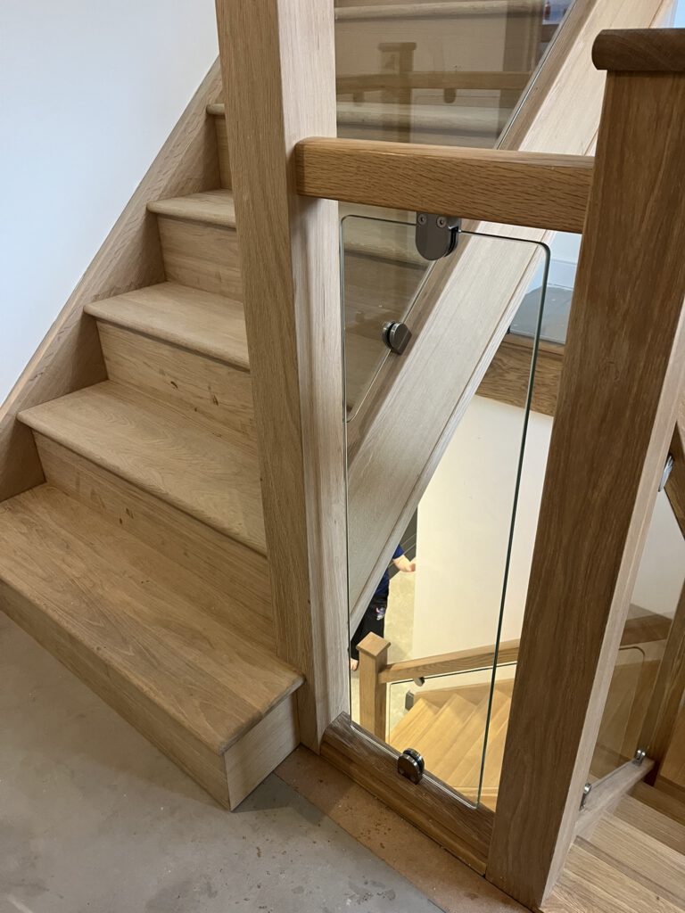 Wooden staircase with glass panels