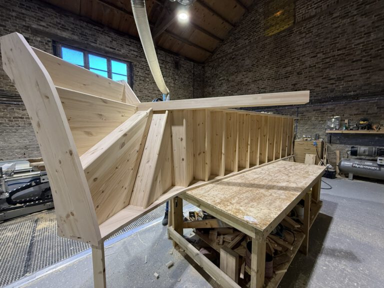 Wooden staircase under construction in workshop